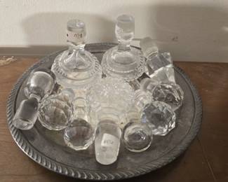 Silver plate with lot of glass decanter caps
