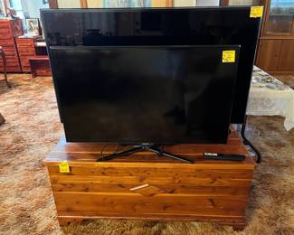 Vintage solid cedar chest and a Samsung Smart TV  and a Samsung 55" TV.
