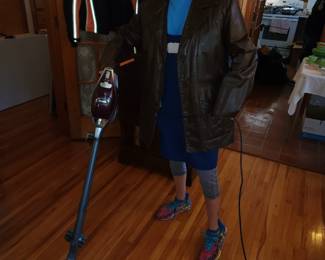 Harley jacket hanging in the back, Fritz modeling a vintage leather jacket and Shark Rocket vacuum cleaner