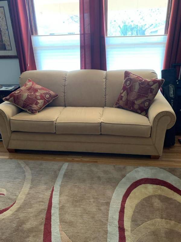 Light gold/tan sofa 85 inches long to outside arms and 65 inside, 37 inches deep with pillows