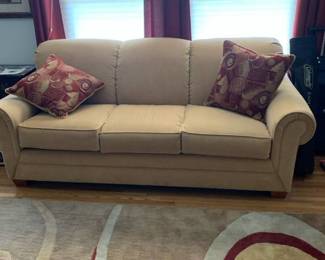 Light gold/tan sofa 85 inches long to outside arms and 65 inside, 37 inches deep with pillows