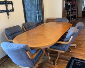 Pedestal 60 inch oak dining table with 2 leaves that store inside table, 18 inches each with 6 chairs