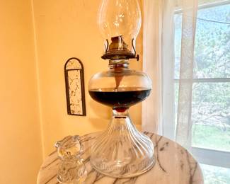 Glass hurricane oil lamp.
