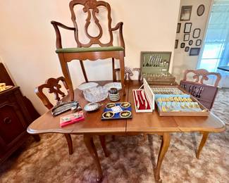 Dining table & needlepoint chairs.