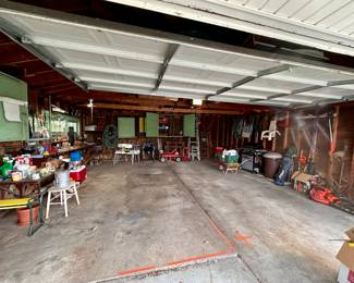 Garage filled with tools, yard equipment and odds and ends.