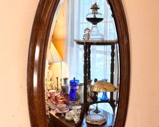 Oval wood framed mirror.