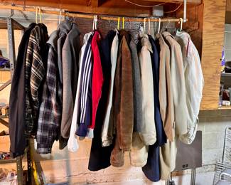 3 racks of men's coats and clothing.