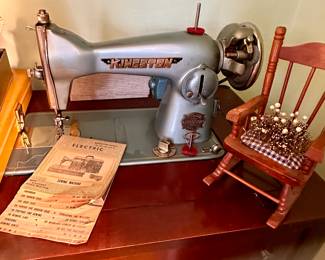 Vintage Kingston sewing machine in cabinet.