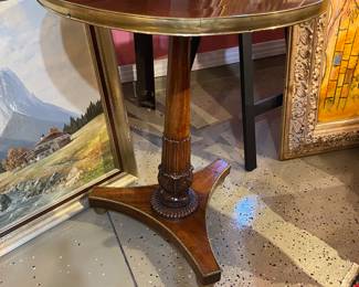 Late 18 century side table with brass trim and footed base