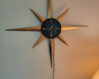 Mid Century Modern Starburst clock, is not currently running. Comes with extra sun spikes.