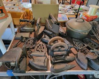Vintage cast iron, irons, and pans.