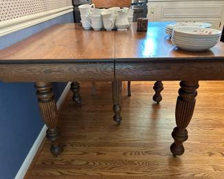 square oak table with 5 legs and one leaf. 42” square