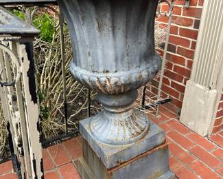 Pair of metal urns. One is damaged 