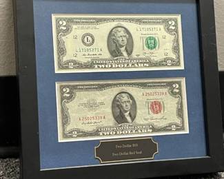 Framed two dollar bills with green and red seals