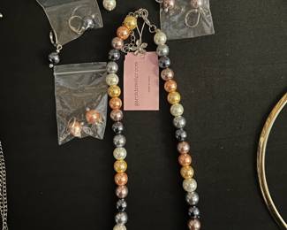 Multi color pearl necklace and four sets of pearl earrings 
