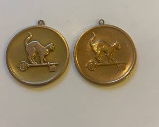 2 gold cat medallions