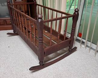 Large decorative wood doll cradle, one end of rocker is broken 22"H x 44"L x approx 26"W (This item is in the Lower Level)
