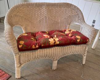 White wicker loveseat with floral cushion, some wear 48"W x 24"D
