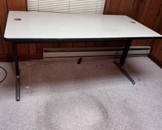 Worktable with sturdy metal legs that may be removable for moving, cord holes at each end, wear and scratches 29"H x 60"W x 28"D (This item is in the Lower Level)