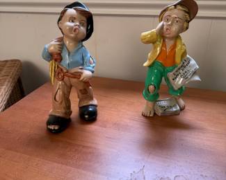 Pair of ceramic newsboy figurines, some wear to paint 9"H