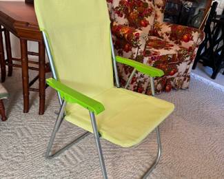 Small vintage tubular metal lawn chair with green plastic arms & mesh cover (Not tested for strength, appears in good condition with some oxidation seen)