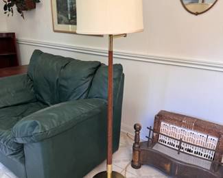 MCM swing-arm floor lamp with shade resting on a milk glass sconce, brass arm, wood body, and brass base, some wear 53"H x 13"W