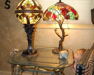 Two Stained Glass Table Lamps Lit, on Iron & Glass End Table