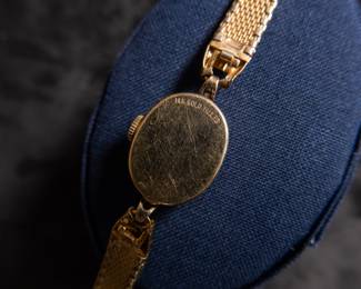 14kt gold-filled Omega ladies watch. Band is from Hong Kong. Unknown service history, but is in working condition. Current band will fit a 6'' wrist.