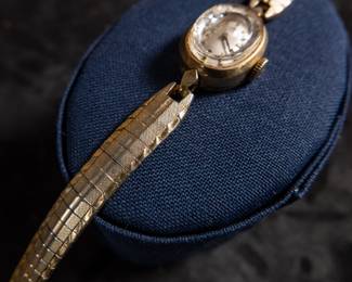 14kt gold-filled Omega ladies watch. Band is from Hong Kong. Unknown service history, but is in working condition. Current band will fit a 6'' wrist.