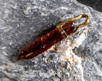 18kt gold pendant wrapped around Red Zincite. Total approx. weight is 8.68 grams and measures 2'' long. Includes original purchase receipt from Crystalarium in West Hollywood, California.