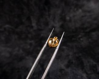 Antique jewelry box with red felt inside and a 14kt gold heart pendant.