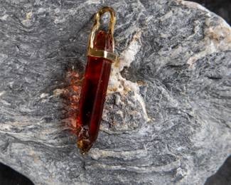 18kt gold pendant wrapped around Red Zincite. Total approx. weight is 8.68 grams and measures 2'' long. Includes original purchase receipt from Crystalarium in West Hollywood, California.