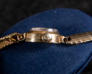 14kt gold-filled Omega ladies watch. Band is from Hong Kong. Unknown service history, but is in working condition. Current band will fit a 6'' wrist.