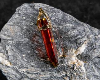 18kt gold pendant wrapped around Red Zincite. Total approx. weight is 8.68 grams and measures 2'' long. Includes original purchase receipt from Crystalarium in West Hollywood, California.