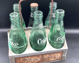 Vintage Coca Cola bottles and tin holder