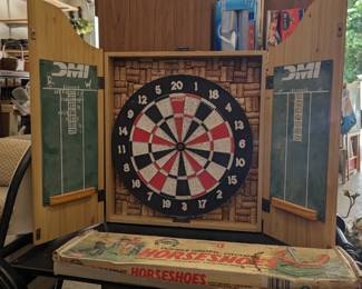 Dart board and vintage horseshoes