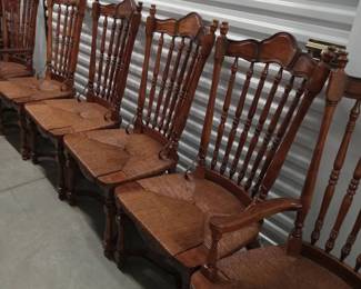 This handsome set of 1970's dining chairs including two armchairs goes with Mediterranean, Spanish, and Jacobean décor. They are very sturdy and the woven rush seats are in excellent condition as is the wood. 