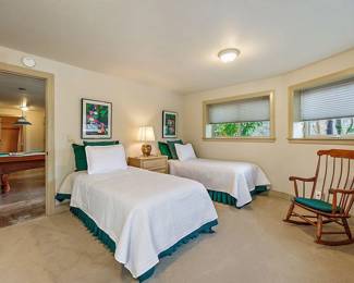 Twin Beds in Excellent Condition. Under those White covers are Hawaiian Style Handmade Quilts. Photos to come. Rocking Chair. Art. Linens. 