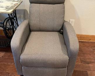 The is an electric, massaging chair, with fabric upholstery