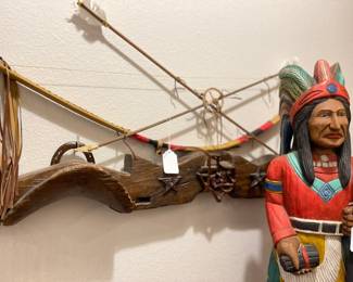 Vintage cattle yoke with Texas metal decorations, above Bow and arrow display