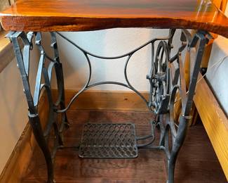 Antique treadle sewing machine base with a live edge wood top