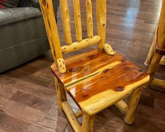 One of the four log dining chairs