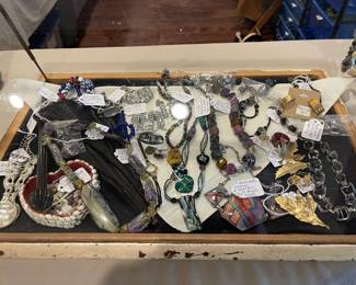 This showcase contains, vintage jewelry, handmade beaded necklaces, earrings, Victorian parasol, rhinestones 