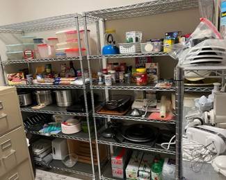 Lots of pans and kitchen equipment, Tupperware and food items