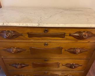 A close look at the drawer details and marble top