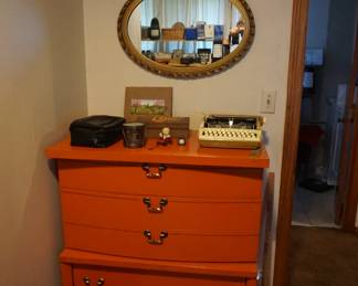 orange chest of drawers, mirror
