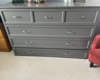 . . . love this grey dresser, which is actually a Murphy bed!!