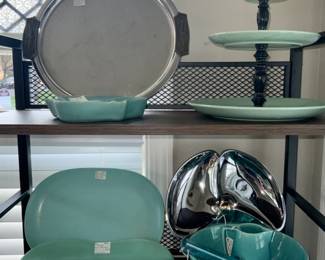 ChTop Shelf:Mid-Century: 13” Chrome  Serving Tray w/Wood HandlesSOLD, Aqua Van Briggle  Pottery Ashtray and Aqua 3 Tier Tidbit Tray. Bottom Shelf:  Texas WareTurquoise 12” Platter, McCoy Turquoise Footed Oval Dish, 3-Part Chrome Relish Sever w/Brass Knob(SOLD), Blue Aluminum Ice Cream Scoop, Franciscan Ware Turquoise Creamer and 9” Veg. Bowl.