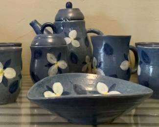 Jarko Zari Blue Glaze Pottery w/a Hand Painted While Flower Coffee Set: Coffee Pot, Sugar Bowl w/lid, Creamer 4 Mugs and an Oval Bowl.  Jarko Zavi (1907–1987) was a Czech-born Canadian ceramist and sculptor who lived and worked principally in Ontario
