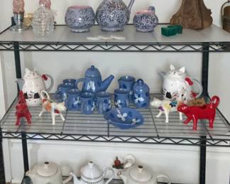 Display of antique Torpedo Vanity Lamps, McCoy Brocade Pottery, Jarko Zari Pottery Coffee Set, Pioneer Woman Cow Creamer Collection and Various Ceramic Teapots